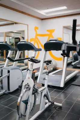 a gym with three bikes parked in a room at Le Dauphin Montréal Centre-Ville in Montréal