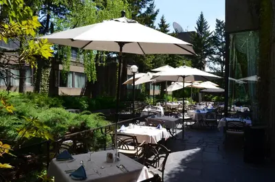 an outdoor restaurant with tables and umbrellas at Hotel Bonaventure Montreal in Montréal