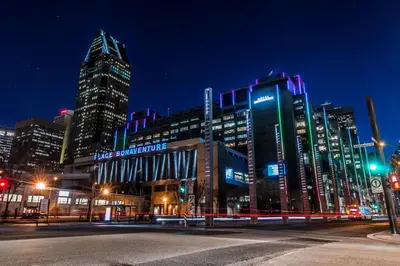 a city street with tall buildings at night at Hotel Bonaventure Montreal in Montréal