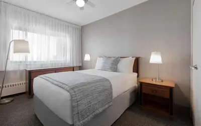 a bedroom with a large bed and a window at L'Appartement Hôtel in Montréal