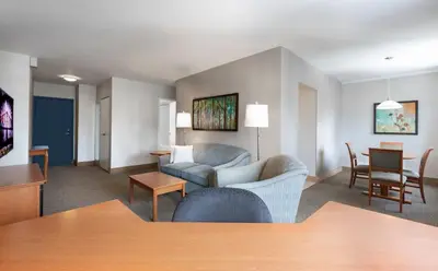 a living room with a couch and a table at L'Appartement Hôtel in Montréal