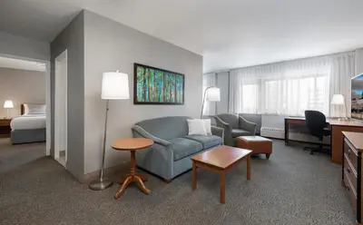 a hotel room with a couch and a bed at L'Appartement Hôtel in Montréal