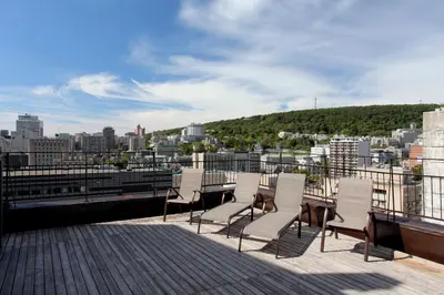 a group of chairs sitting on top of a building at L'Appartement Hôtel in Montréal