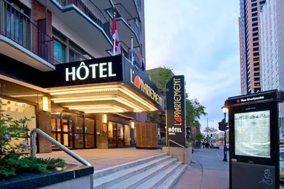 a hotel building with a hotel sign on a street at L'Appartement Hôtel in Montréal