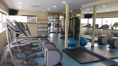 a gym with rows of treadmills and exercise machines at Le Square Phillips Hôtel & Suites in Montréal