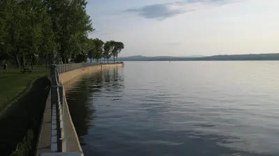 a large body of water with trees on the side at À Tout Venant B&B in Magog-Orford