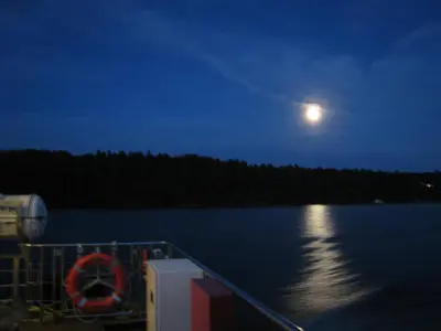 a moon over a body of water at night at À Tout Venant B&B in Magog-Orford