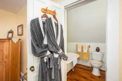 a bathroom with a towel rack and a toilet at Les Matins de Victoria in Waterloo