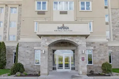 a building with an entrance to a hotel at Imperia Hotel & Suites Saint-Eustache in Saint-Eustache