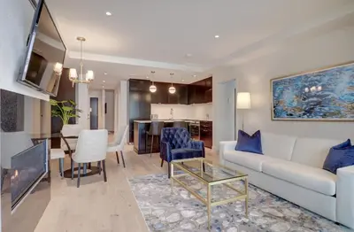a living room with a couch and a dining room at Ripplecove Hotel & Spa in Ayer's Cliff
