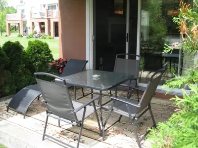 a black table and chairs on a patio at Arkadia Condo Magog in Magog-Orford