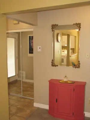 a room with a red cabinet and a mirror at Arkadia Condo Magog in Magog-Orford