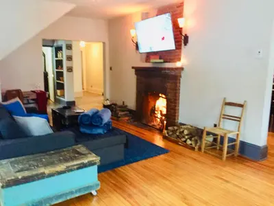 a living room with a fireplace and a tv at Suites North Hatley in North Hatley