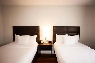 two beds sitting next to each other in a room at Hotel Newstar Montréal in Montréal