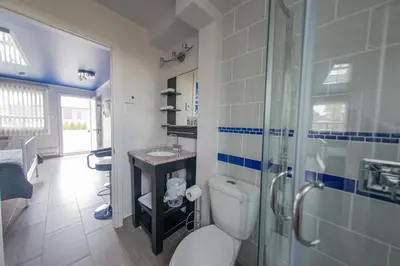 a bathroom with a toilet and a glass shower at Auberge St. Jacques in Montréal