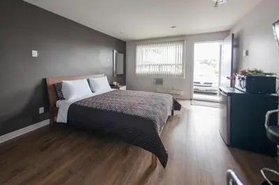 a bedroom with a bed and a large window at Auberge St. Jacques in Montréal