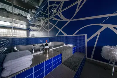 a blue bathroom with a tub and a sink at Auberge St. Jacques in Montréal