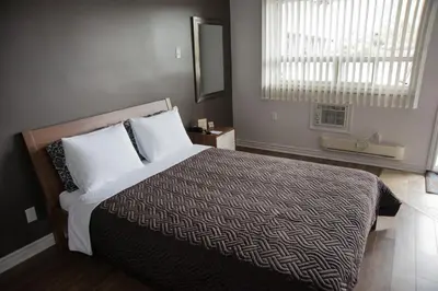a bedroom with a large bed and a window at Auberge St. Jacques in Montréal