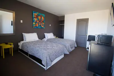 a hotel room with a bed and a tv at Auberge St. Jacques in Montréal