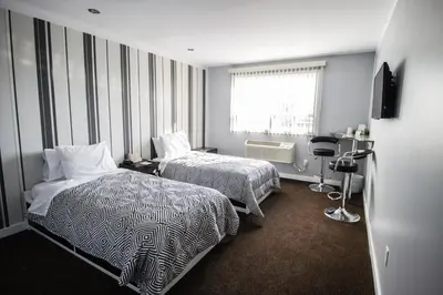 a hotel room with two beds and a window at Auberge St. Jacques in Montréal