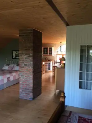 a room with a brick pillar in the middle of a house at La Maison Pamaljolie in Ayer's Cliff