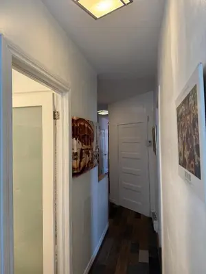 a hallway with a white door and a ceiling at Le 2316 in Saint-Hyacinthe