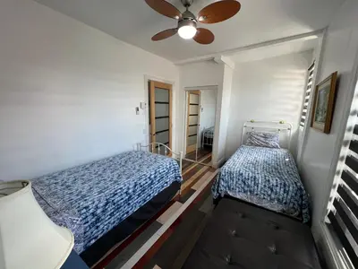 a bedroom with two beds and a ceiling fan at Le 2316 in Saint-Hyacinthe