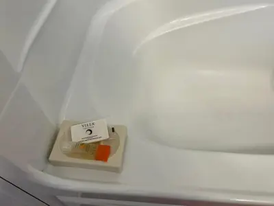 a white toilet with a box on the side of it at Le 2316 in Saint-Hyacinthe
