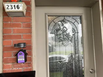 a door with a gate with a sign on it at Le 2316 in Saint-Hyacinthe