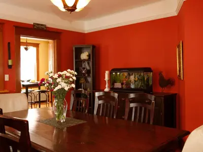 a dining room with a table with a vase of flowers at Au Virage B&B in Magog-Orford