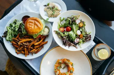 a tray with plates of food on a table at Hôtel Birks Montréal in Montréal