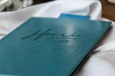 a blue book sitting on top of a table at Hôtel Birks Montréal in Montréal