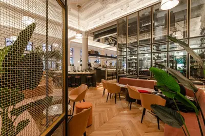 a restaurant with chairs and tables in a building at Hôtel Birks Montréal in Montréal