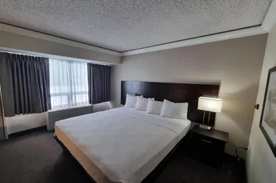 a hotel room with a large bed and a window at Travelodge by Wyndham Trois-Rivieres in Trois-Rivières