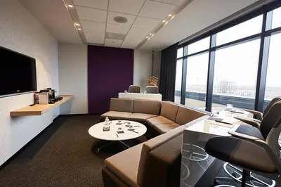 an office with a couch and a table and chairs at Hôtel Escad Quartier DIX30 in Brossard