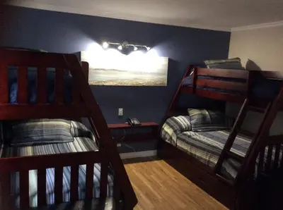 a bedroom with two bunk beds and a window at Miami Motel inc in Trois-Rivières