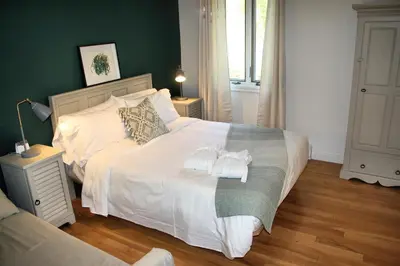 a bedroom with a bed with two towels on it at Domaine Jolivent in Lac-Brome