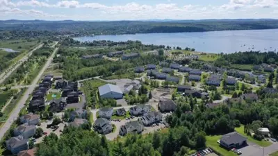 an aerial view of a town with a lake at Condo Entre Ville/Nature in Magog-Orford