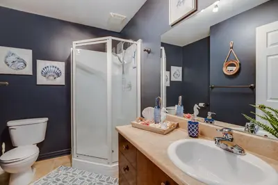 a bathroom with a shower and a sink and a toilet at Condo Entre Ville/Nature in Magog-Orford