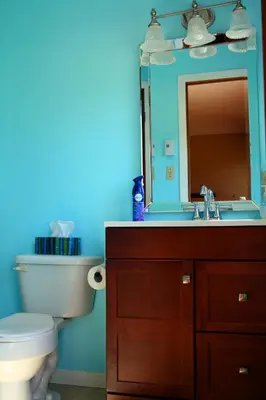 a bathroom with a toilet and a sink and a mirror at Ranch St-Hubert in Saint-Herménégilde