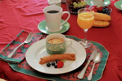 a table with a plate of food and a cup of coffee at Ranch St-Hubert in Saint-Herménégilde