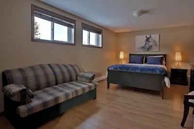 a bedroom with a bed and a couch at Ranch St-Hubert in Saint-Herménégilde