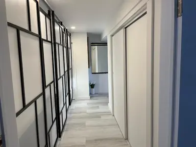 a hallway with white walls and black framed doors at Domaine Gagnon in Saint Sebastien