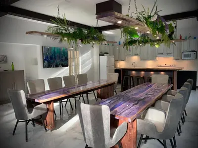 a dining room with a wooden table and chairs at Domaine Gagnon in Saint Sebastien
