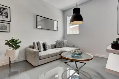 a living room with a couch and a table at Les Lofts du Centre by Simplissimmo in Montréal