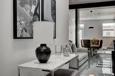a living room with a table with a lamp on it at Les Lofts du Centre by Simplissimmo in Montréal
