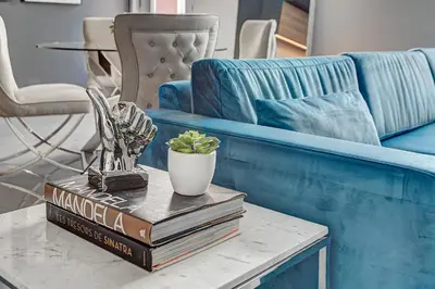 a table with books and a trophy and a couch at Les Lofts du Centre by Simplissimmo in Montréal