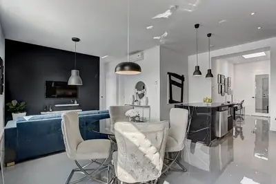 a living room with a couch and a table and chairs at Les Lofts du Centre by Simplissimmo in Montréal