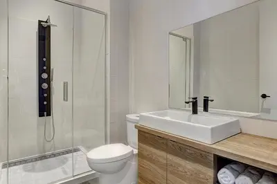 a bathroom with a sink and a toilet and a shower at Les Lofts du Centre by Simplissimmo in Montréal
