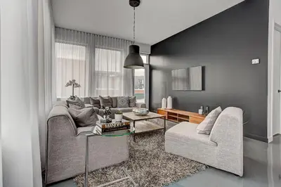 a living room with two couches and a table at Les Lofts du Centre by Simplissimmo in Montréal